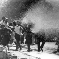 Children's Crusade protesters are sprayed by firehoses.