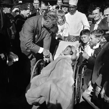 The New York governor shakes the hand of Mary Frances Jasper, a patient at the polio treatment center in Warm Springs, Ga.