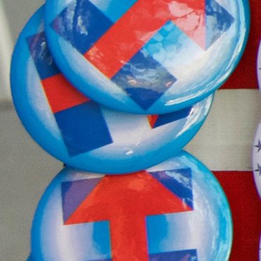 A vendor sells pins to supporters of Democratic contender Hillary Clinton at a May 26, 2016, rally in San Jose, Calif., shortly before that state's primary.