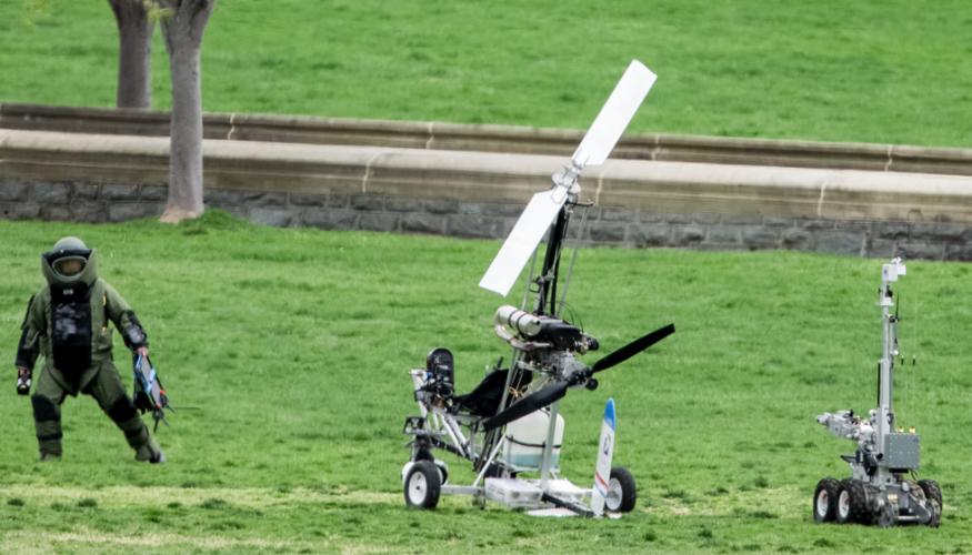 A member of the bomb squad inspects the gyrocopter.